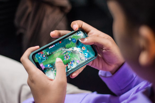 A man playing an action mobile game on his smartphone