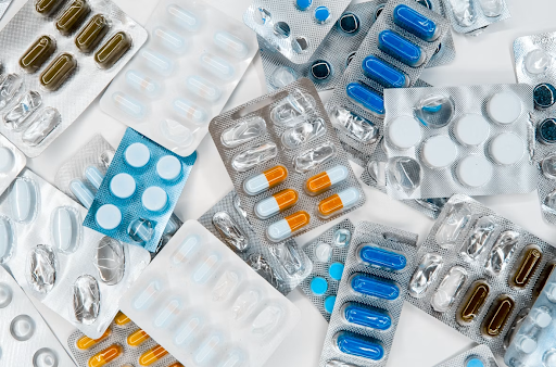 A pile of colorful pills and capsules arranged side by side on a table