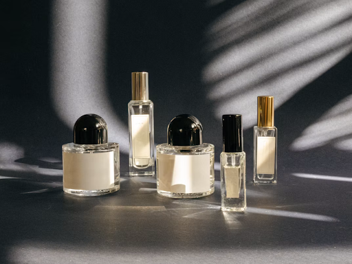 A collection of perfume bottles displayed on a grey surface