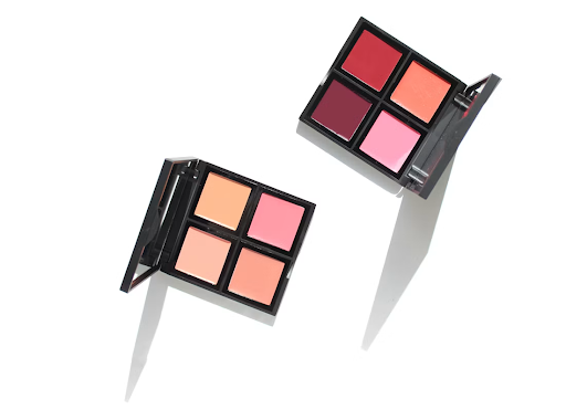 A flat lay of lipstick and cream blush palettes for cosmetic and makeup applications